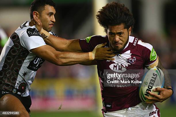 Alex Johnston of the Rabbitohs tackled Jorge Taufua of the Eagles during the round 22 NRL match between the Manly Sea Eagles and the South Sydney...