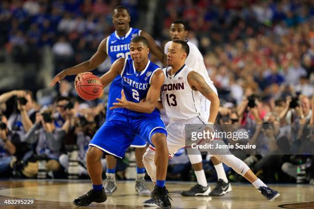 Shabazz Napier of the Connecticut Huskies defends against Aaron Harrison of the Kentucky Wildcats during the NCAA Men's Final Four Championship at...