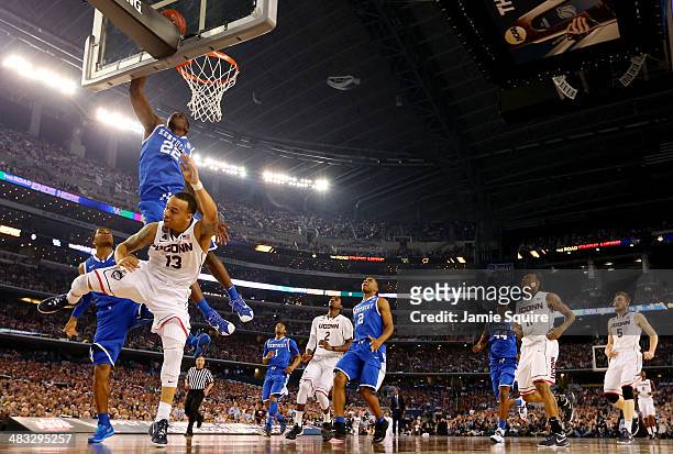 Shabazz Napier of the Connecticut Huskies goes to the basket as Alex Poythress of the Kentucky Wildcats defends during the NCAA Men's Final Four...