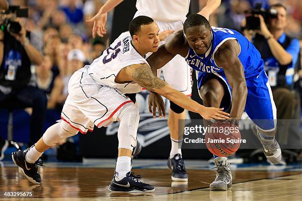 Shabazz Napier of the Connecticut Huskies and Julius Randle of the Kentucky Wildcats battle for a loose ball during the NCAA Men's Final Four...