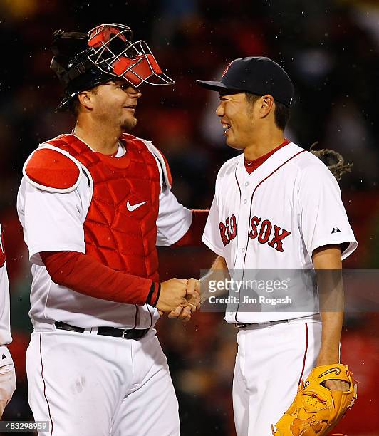 Koji Uehara of the Boston Red Sox celebrates with A.J. Pierzynski a pitching in the 9th inning against the Texas Rangers to lead the team to a 5-1...