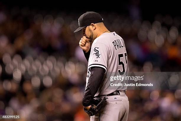 Starting pitcher Felipe Paulino of the Chicago White Sox blows into his hand prior to being pulled out of the game during the fifth inning against...