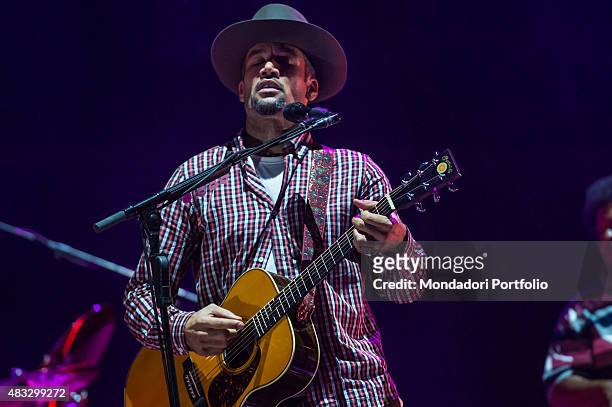 The American singer and musician Ben Harper playing the guitar during the concert at Assago Summer Arena and wearing a checked shirt and a Borsalino...