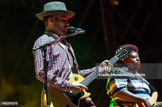 The American singer and musician Ben Harper singing and playing the guitar during his concert at Assago Summer Arena. By his side the American...