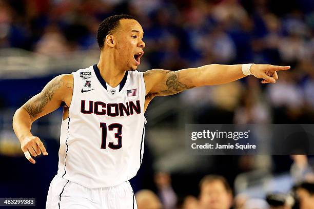 Shabazz Napier of the Connecticut Huskies calls a play against the Kentucky Wildcats during the NCAA Men's Final Four Championship at AT&T Stadium on...