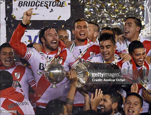 Fernando Cavenaghi and Gonzalo Martinez celebrate with the trophy after winning a second leg final match between River Plate and Tigres UANL as part...