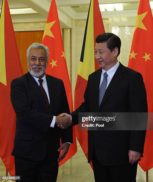 Chinese President Xi Jinping greets East Timor Prime Minister Xanana Gusmao before a meeting at the Great Hall of the People April 8, 2014 in...