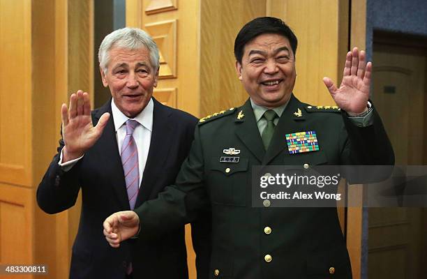 Secretary of Defense Chuck Hagel and Chinese Minister of Defense Chang Wanquan gesture to members of the media prior to their meeting at the Chinese...