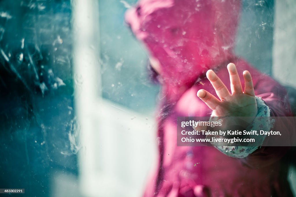 Little hand presses up against a window