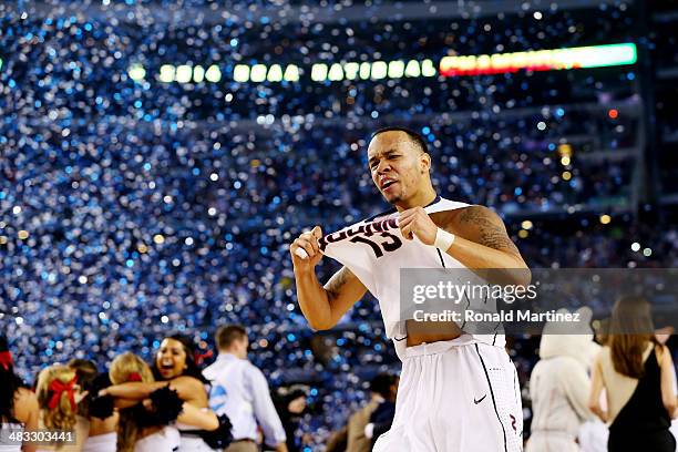 Shabazz Napier of the Connecticut Huskies celebrates on the court after defeating the Kentucky Wildcats 60-54 in the NCAA Men's Final Four...