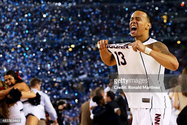 Shabazz Napier of the Connecticut Huskies celebrates on the court after defeating the Kentucky Wildcats 60-54 in the NCAA Men's Final Four...