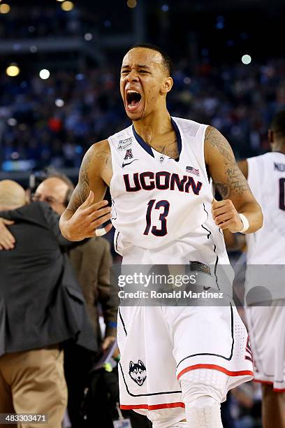 Shabazz Napier of the Connecticut Huskies celebrates on the court after defeating the Kentucky Wildcats 60-54 in the NCAA Men's Final Four...