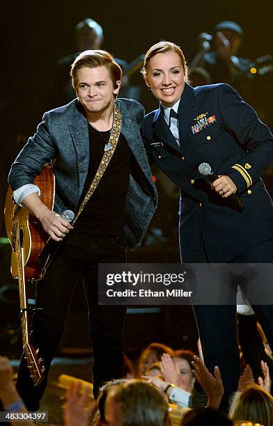 Recording artist Hunter Hayes and Coast Guard Lt. J.g. Katie Spira perform onstage during ACM Presents: An All-Star Salute To The Troops at the MGM...