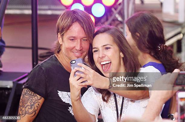 Musician Keith Urban poses for a selfie with a fan during his performance on NBC's "Today" at Rockefeller Plaza on August 7, 2015 in New York City.