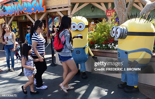 People dressed as Minions attract visitors at Universal Studios where the Despicable Me Minion Mayhem attraction was still under construction on...