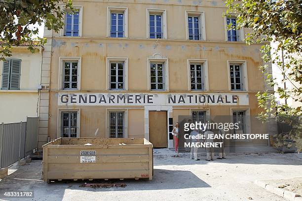 People speak in front of the National Gendarmerie office, closed for works before the foundation of a museum, in the French Mediterranean city of...