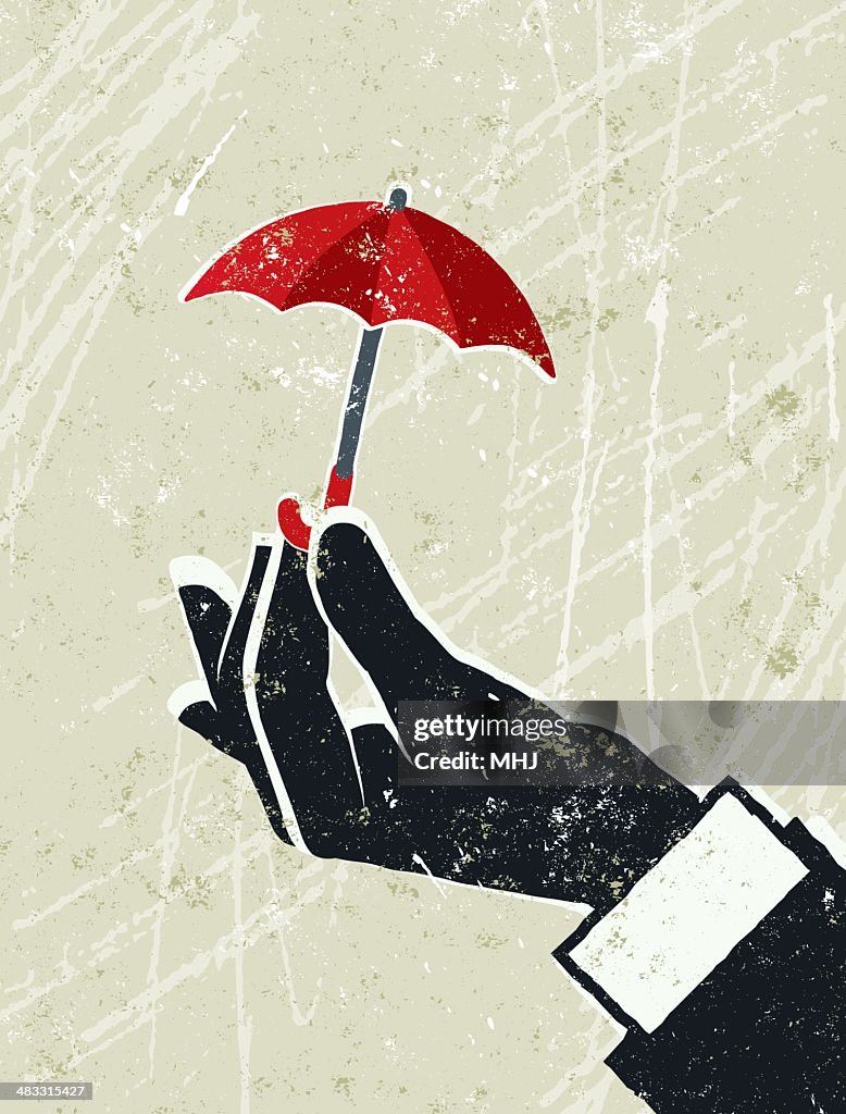 Business Man's Hand Holding a Tiny Umbrella