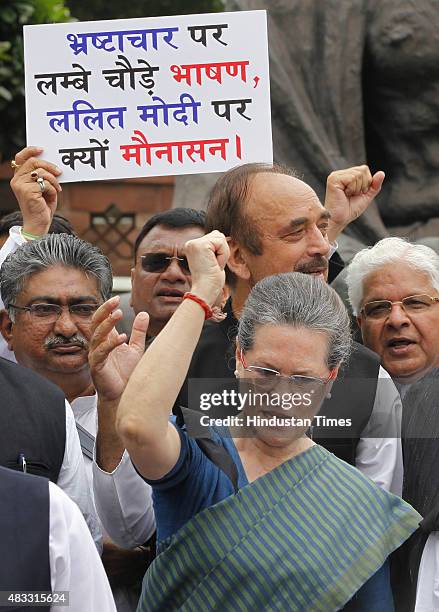 Congress President Sonia Gandhi shouts slogans against the Modi Government during a protest with leaders of Congress, RJD and SP during the Monsoon...