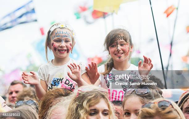 Children enjoy the music at the Glastonbury Festival at Worthy Farm, Pilton on June 28, 2015 in Glastonbury, England.