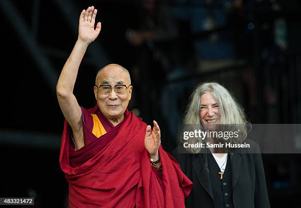 The Dalai Lama appears with Patti Smith on The Pyramid Stage at the Glastonbury Festival at Worthy Farm, Pilton on June 28, 2015 in Glastonbury,...