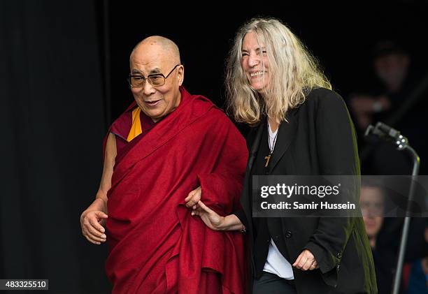 The Dalai Lama appears with Patti Smith on The Pyramid Stage at the Glastonbury Festival at Worthy Farm, Pilton on June 28, 2015 in Glastonbury,...