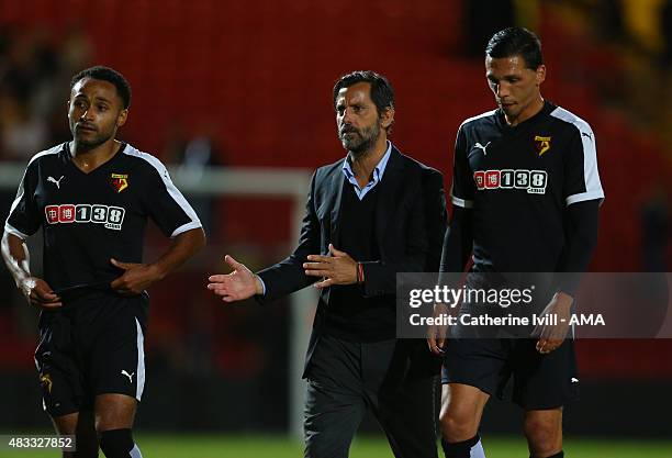 Quique Sanchez Flores manager of Watford speaks with with Ikechi Anya and Jose Holebas of Watford after the pre-season friendly between Watford and...