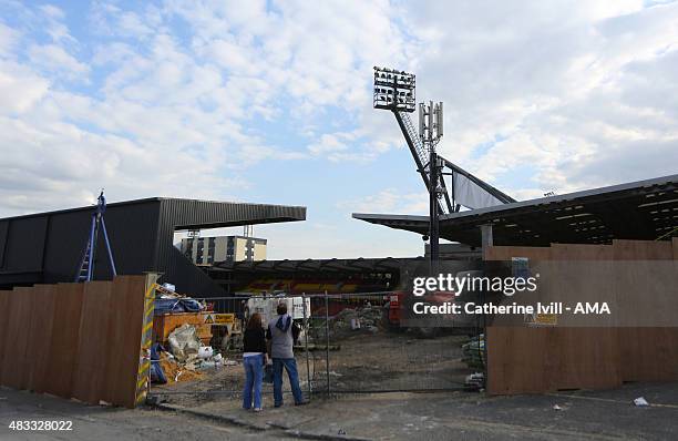 Fans look through the fence as building work continues before the pre-season friendly between Watford and Seville at Vicarage Road on July 31, 2015...
