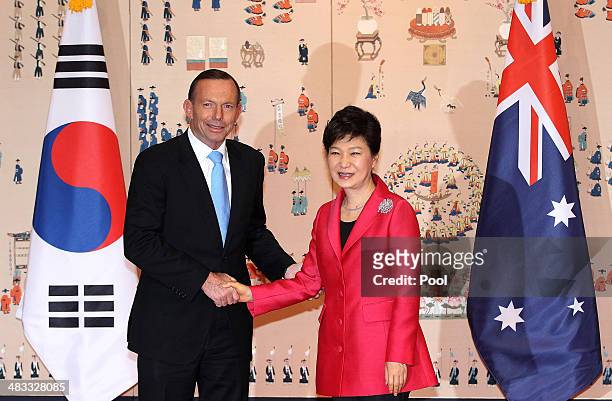 Australian Prime Minister Tony Abbott shakes hands with South Korean President Park Geun-Hye before their meeting at the presidential blue house on...