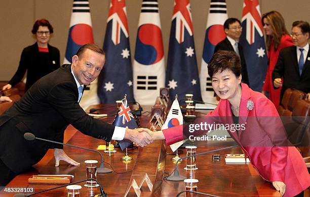 Australian Prime Minister Tony Abbott shakes hands with South Korean President Park Geun-Hye during their meeting at the presidential blue house on...