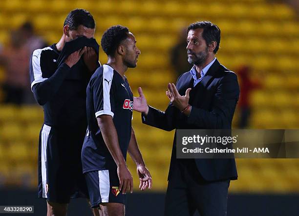 Quique Sanchez Flores manager of Watford speaks with with Ikechi Anya and Jose Holebas of Watford after the pre-season friendly between Watford and...