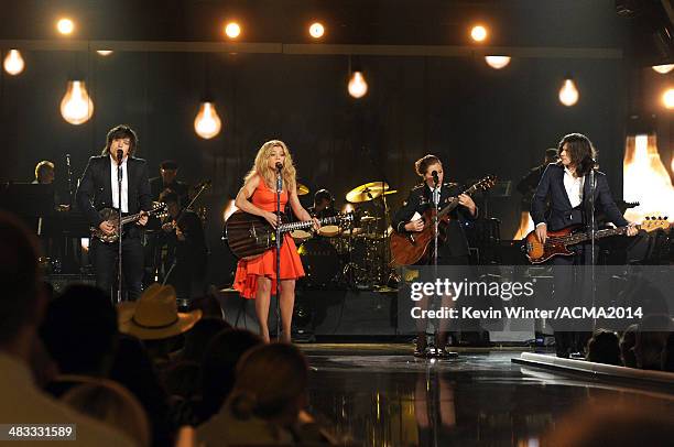 Army Spc. Kelly Gregg performs with musicians Neil Perry, Kimberly Perry and Reid Perry of The Band Perry onstage during ACM Presents: An All-Star...