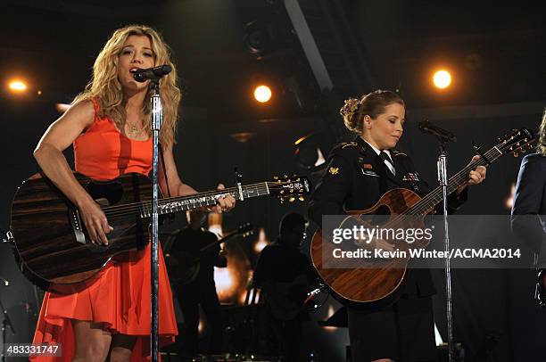 Musician Kimberly Perry of The Band Perry and Army Spc. Kelly Gregg perform onstage during ACM Presents: An All-Star Salute To The Troops at the MGM...