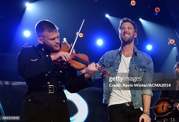 Marine Capt. John Ed Auer and musician Charles Kelley of Lady Antebellum perform onstage during ACM Presents: An All-Star Salute To The Troops at the...