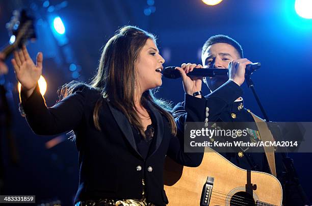 Musician Hillary Scott of Lady Antebellum and Marine Capt. Matt Smith perform onstage during ACM Presents: An All-Star Salute To The Troops at the...