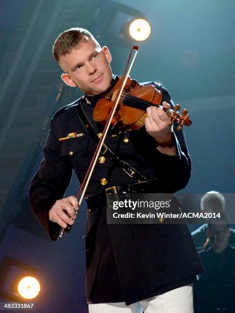 Marine Capt. John Ed Auer performs onstage during ACM Presents: An All-Star Salute To The Troops at the MGM Grand Garden Arena on April 7, 2014 in...