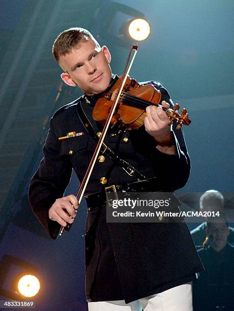 Marine Captain John Auer performs onstage during ACM Presents: An All-Star Salute To The Troops at the MGM Grand Garden Arena on April 7, 2014 in Las...