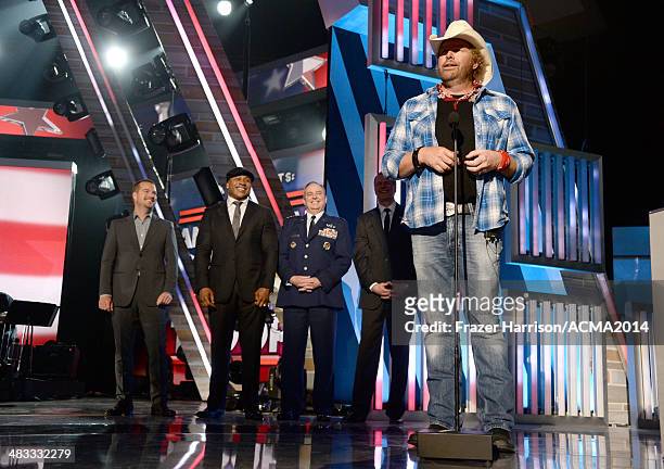 Actors Chris O'Donnell LL Cool J and recording artist Toby Keith speaks onstage with members of the armed forces during ACM Presents: An All-Star...