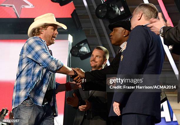 Fecording artist Toby Keith, actors Chris O'Donnell, LL Cool speaks onstage with members of the armed forces during ACM Presents: An All-Star Salute...