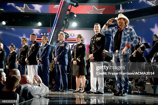 Recording artist Toby Keith speaks onstage with members of the armed forces during ACM Presents: An All-Star Salute To The Troops at the MGM Grand...