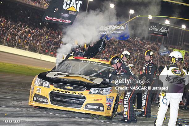 The pit crew for the Caterpillar Chevy SS, driven by Ryan Newman, works to repair damage to the car during the running of the Daytona 500 at the...