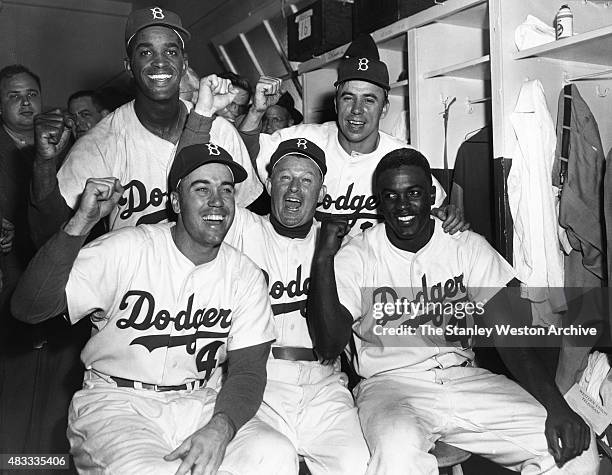 Left to Right: Duke Snider, Manager Chuck Dressen, Jackie Robinson; Back Row: Joe Black, Pee Wee Resse; show their excitment after wining game one of...