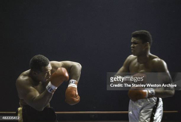 Cassius Clay and Archie Moore trade blows during their bout on November 15, 1962 at Los Angeles Sports Arena in Los Angeles, California.