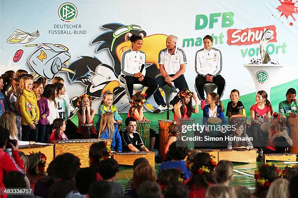 Dzsenifer Marozsan and Annike Krahn are intervewed during a visit at Adolf Delp Elementary School on April 8, 2014 in Mannheim, Germany.