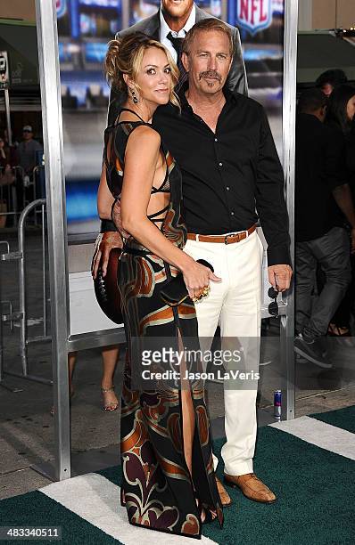 Actor Kevin Costner and wife Christine Baumgartner attend the premiere of "Draft Day" at Regency Bruin Theatre on April 7, 2014 in Los Angeles,...