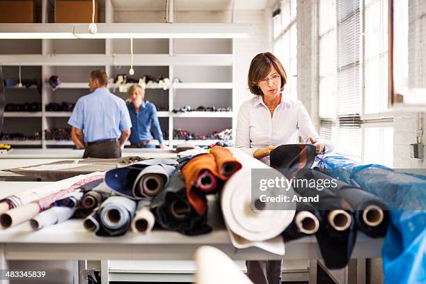 female professional designer at work - clothing factory stock pictures, royalty-free photos & images