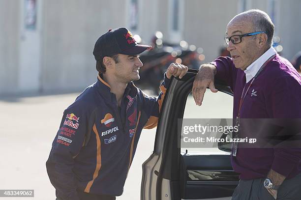 Dani Pedrosa of Spain and Repsol Honda Team speaks with Carmelo Ezpeleta of Spain and Dorna CEO in paddock during the MotoGp Red Bull U.S....