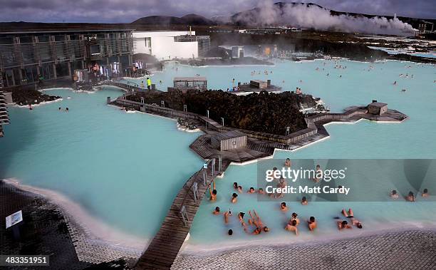 Visitors sit in the geothermal waters at the Blue Lagoon close to the Icelandic capital of Reykjavik on April 7, 2014 in Reykjavik, Iceland. Since...