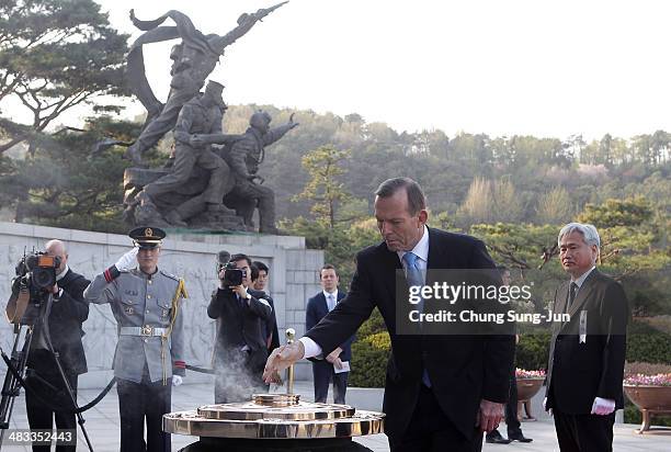 Australian Prime Minister Tony Abbott burns incense at Seoul National Cemetery during his visit to South Korea on April 8, 2014 in Seoul, South...