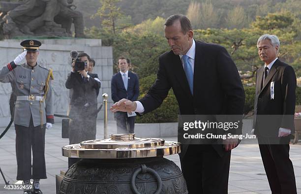 Australian Prime Minister Tony Abbott burns incense at Seoul National Cemetery during his visit to South Korea on April 8, 2014 in Seoul, South...