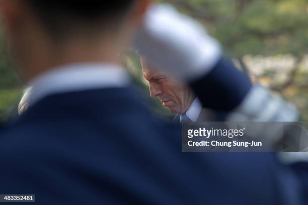 Australian Prime Minister Tony Abbott pays a silent tribute at Seoul National Cemetery during his visit to South Korea on April 8, 2014 in Seoul,...